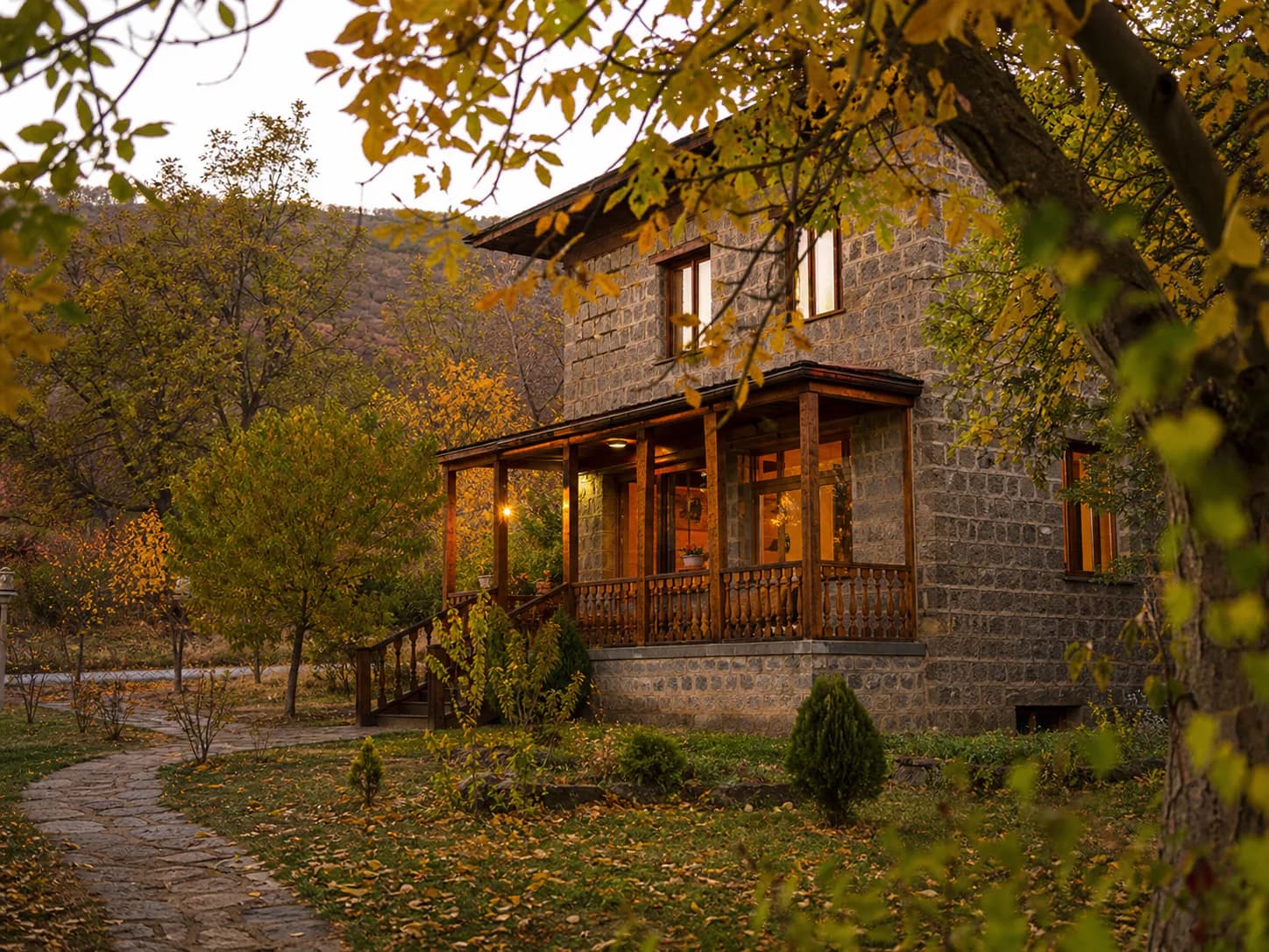 Voske Ashun's stone guesthouse in its autumn garden